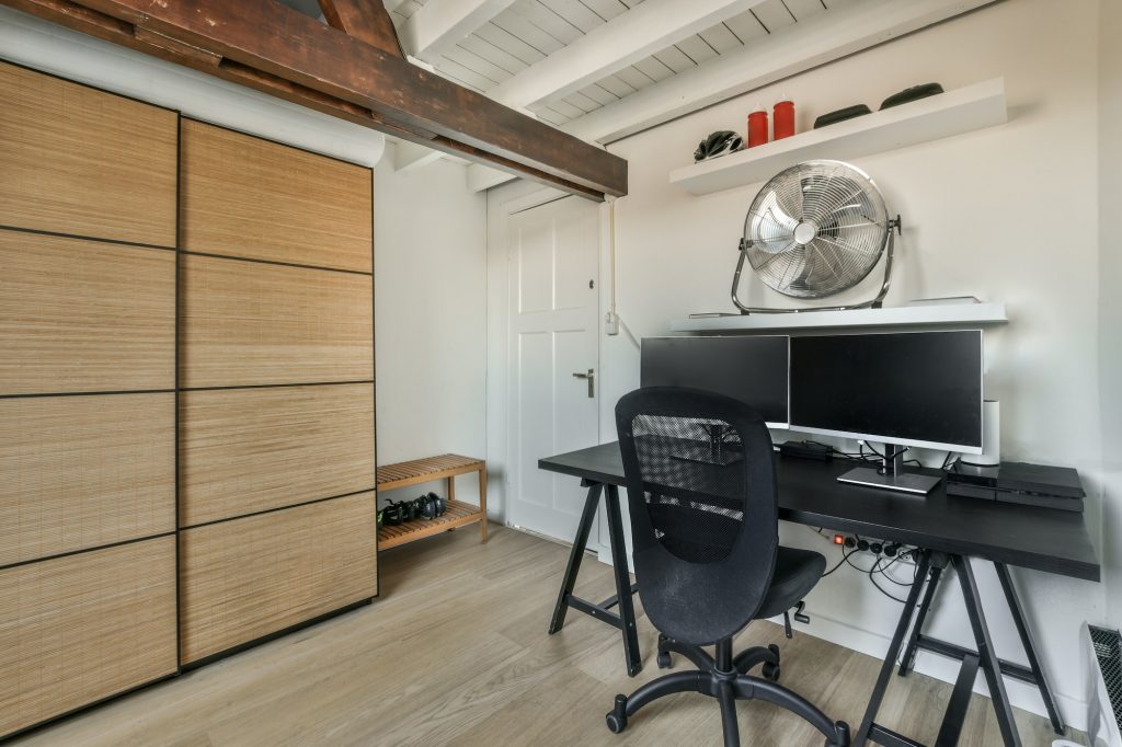 Attic room with working desk and sofa